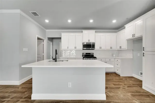 a large kitchen with stainless steel appliances