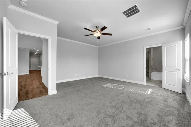 wooden floor in an empty room and a ceiling fan