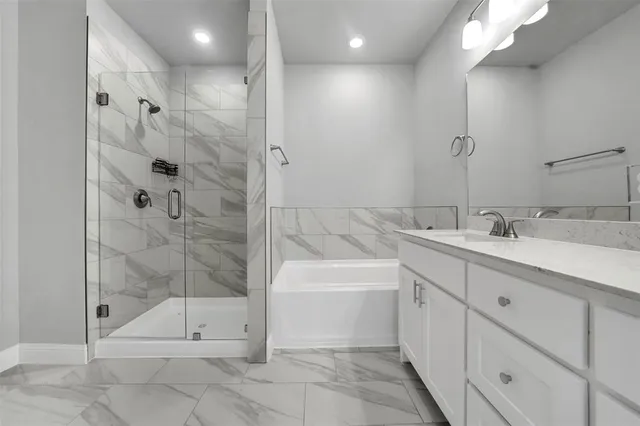 a bathroom with a shower sink and mirror