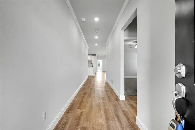 a view of a hallway with wooden floor