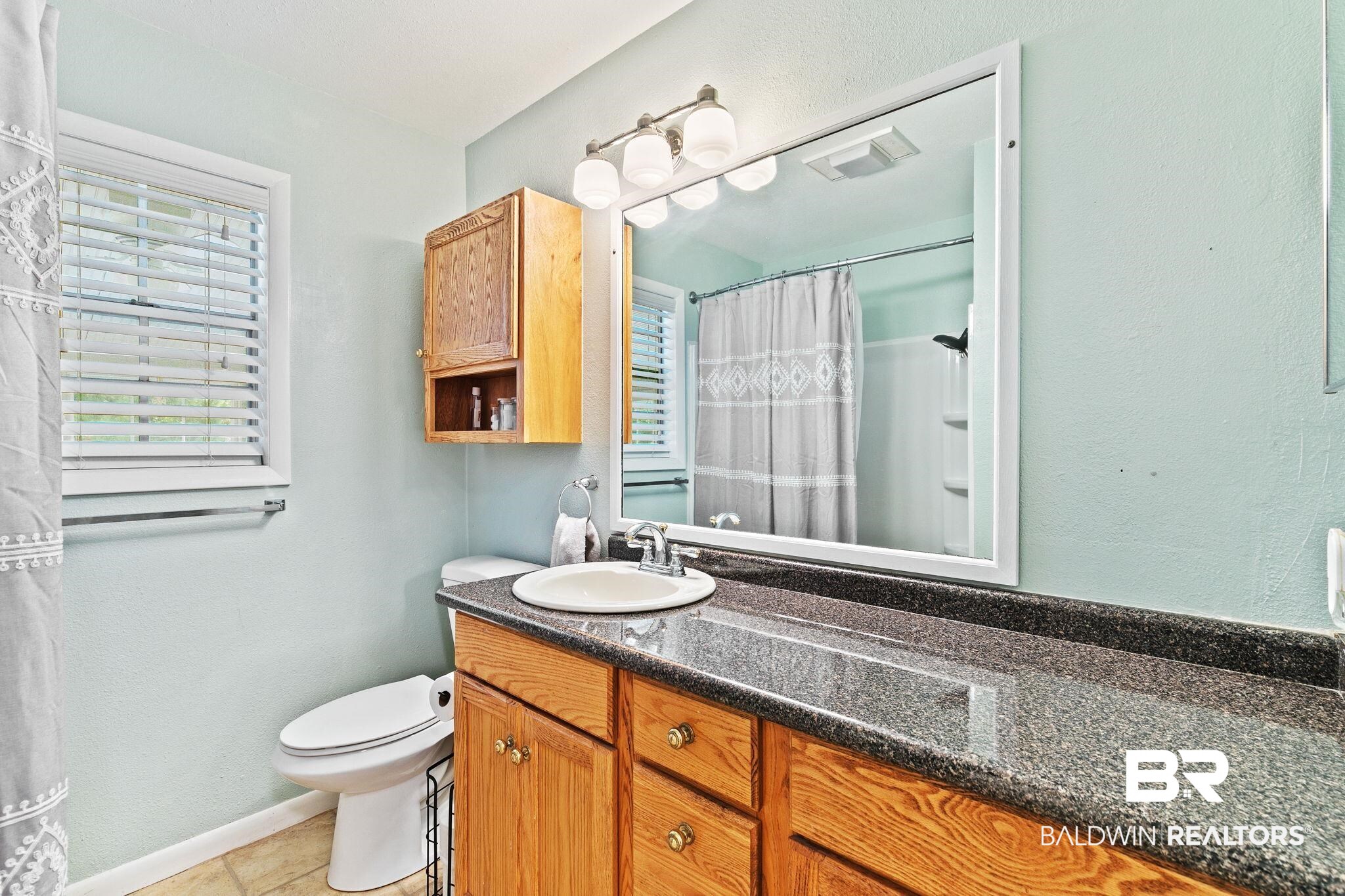 14 Lee Circle Daphne, AL 36527 - Photo 43 of 83 Bathroom with tile floors, vanity, and toilet
