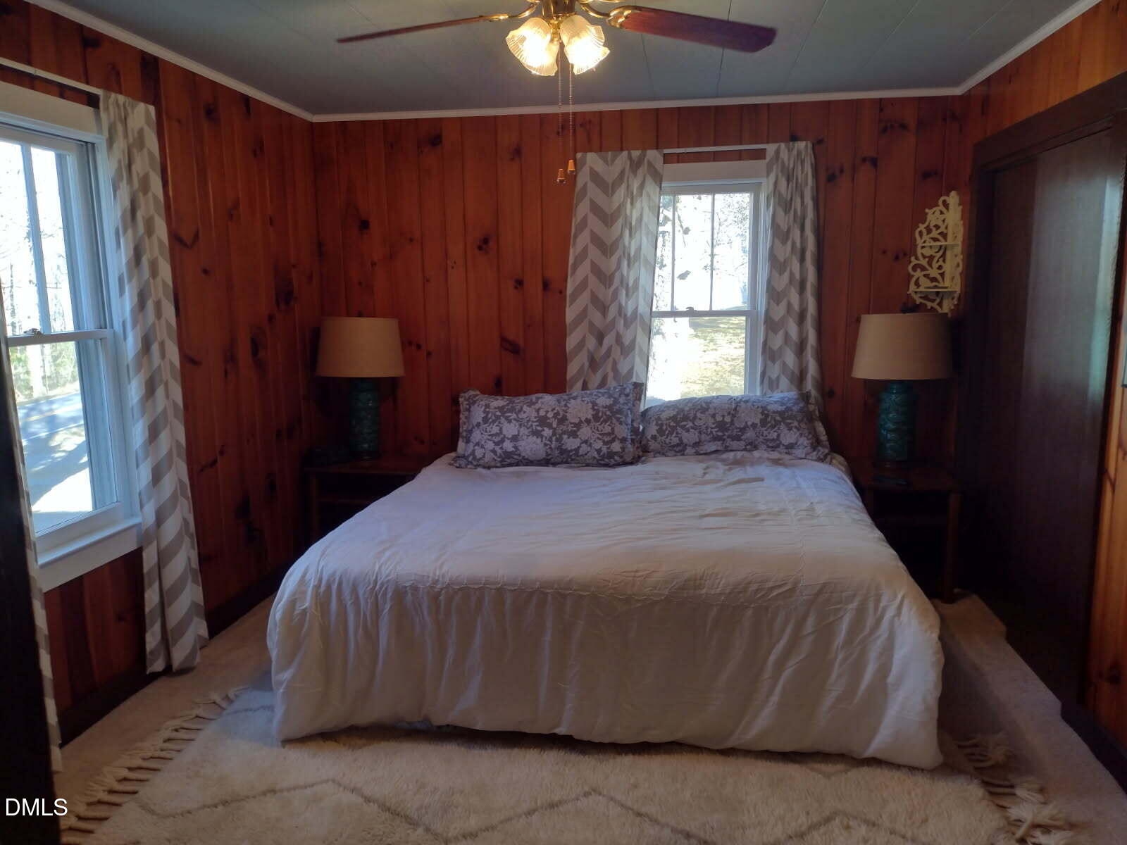 659 Chestnut Grove Road Spruce Pine, NC 28777 - Photo 13 of 21 a bedroom with a bed and a chandelier