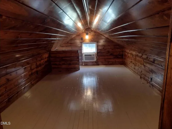 a view of a patio with table and chairs with wooden floor and fence