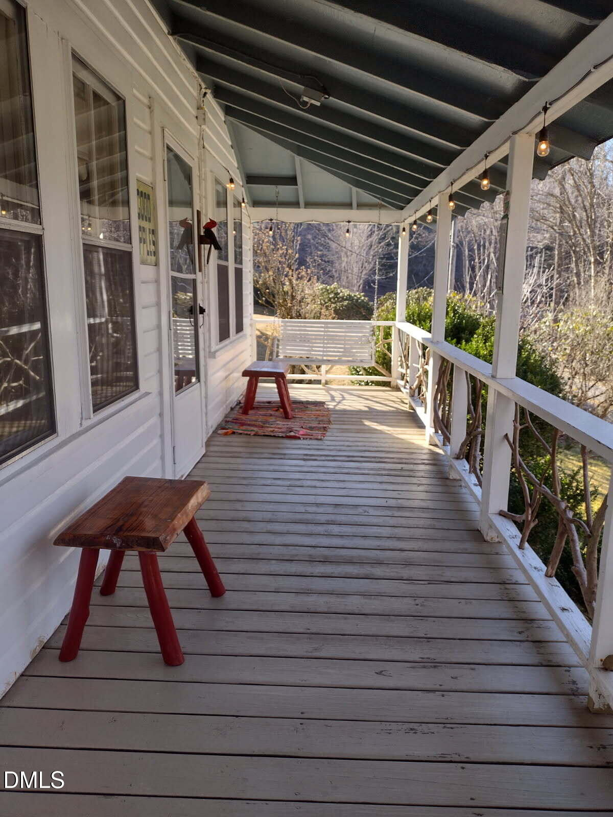 659 Chestnut Grove Road Spruce Pine, NC 28777 - Photo 17 of 21 a view of a patio with table and chairs with wooden floor and fence