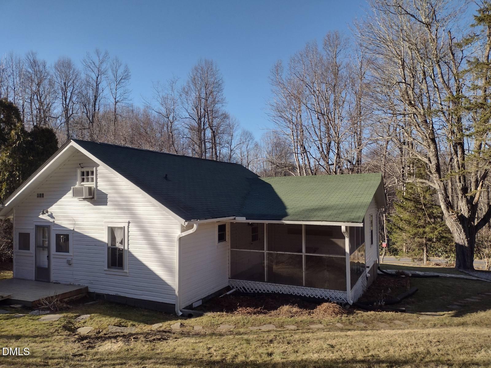 659 Chestnut Grove Road Spruce Pine, NC 28777 - Photo 2 of 21 a front view of a house with a yard