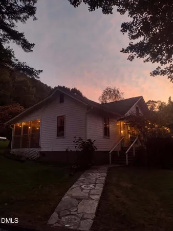 a view of house with backyard and garden