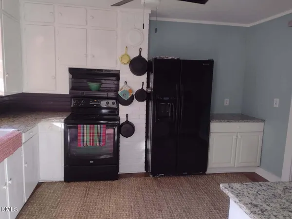 a kitchen with a stove a microwave and cabinets