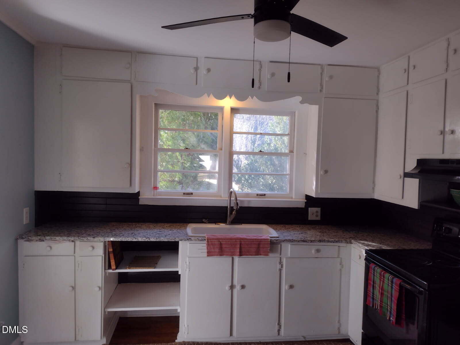 659 Chestnut Grove Road Spruce Pine, NC 28777 - Photo 9 of 21 a kitchen with a stove a microwave and cabinets