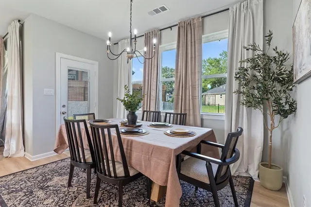 a view of a dining room with furniture window and wooden floor
