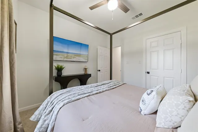 a bedroom with a bed and a chandelier