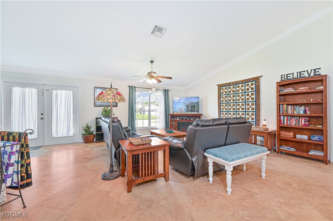 18217 Sycamore Road Fort Myers, FL 33967 - Photo 11 of 35 a living room with furniture a bookshelf and a window