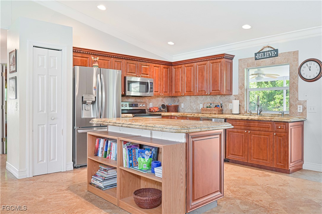 18217 Sycamore Road Fort Myers, FL 33967 - Photo 13 of 35 a kitchen with stainless steel appliances granite countertop a stove a sink and a refrigerator with cabinets