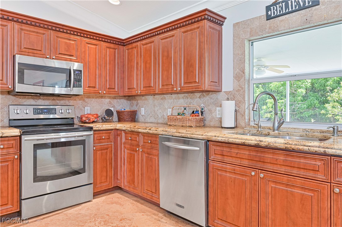 18217 Sycamore Road Fort Myers, FL 33967 - Photo 15 of 35 a kitchen with stainless steel appliances granite countertop a stove a sink and a microwave