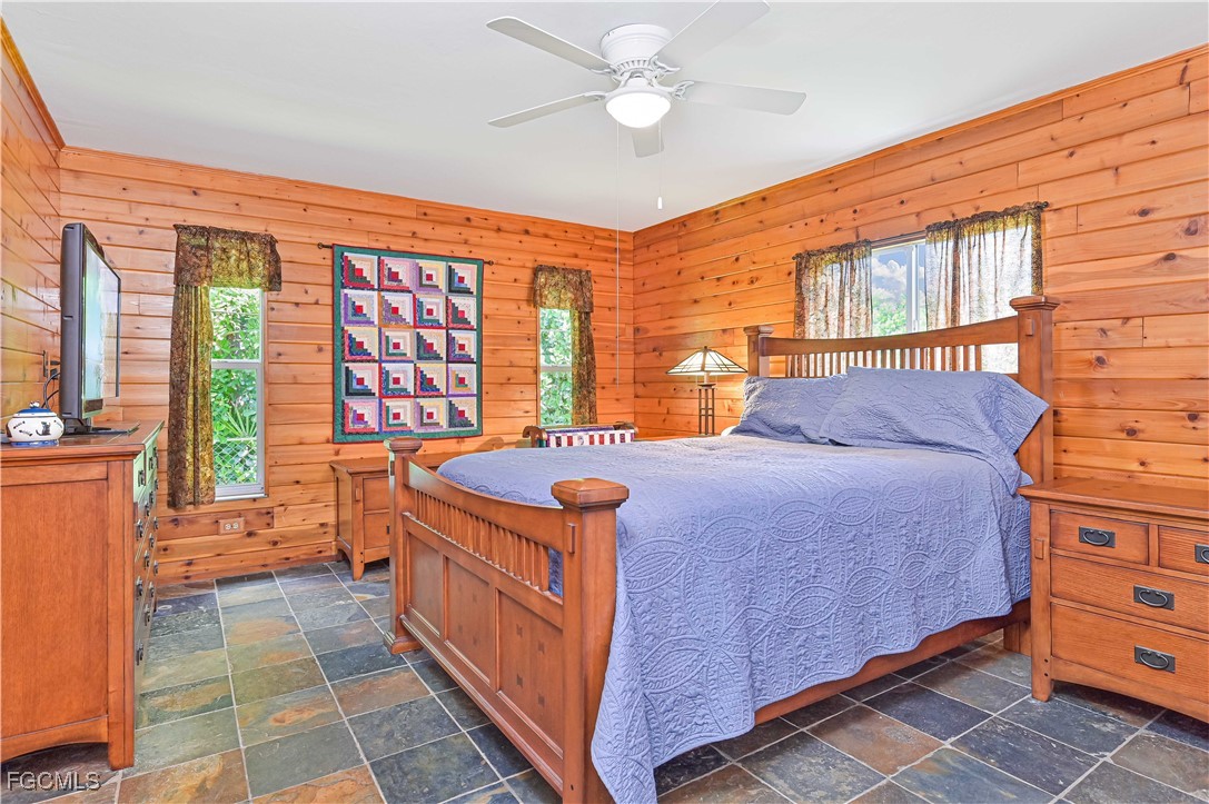 18217 Sycamore Road Fort Myers, FL 33967 - Photo 18 of 35 a bedroom with a bed and a dresser next to a window