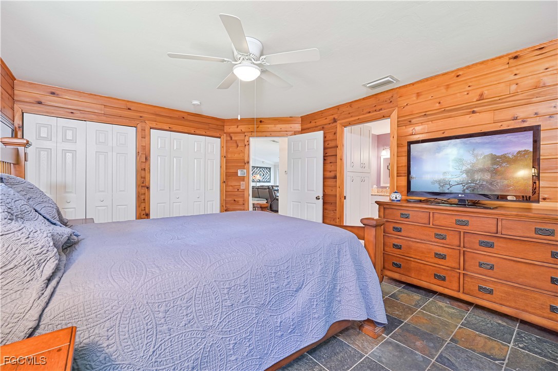 18217 Sycamore Road Fort Myers, FL 33967 - Photo 19 of 35 a bedroom with a large bed and flat tv screen on dresser