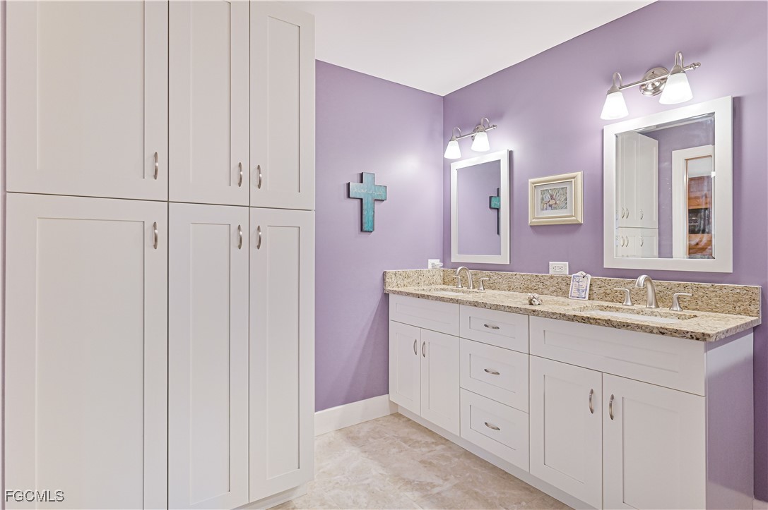 18217 Sycamore Road Fort Myers, FL 33967 - Photo 20 of 35 a bathroom with a granite countertop sink and a mirror
