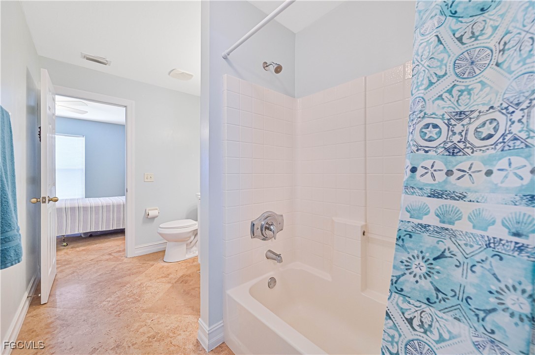 18217 Sycamore Road Fort Myers, FL 33967 - Photo 25 of 35 a bathroom with a bathtub and a toilet