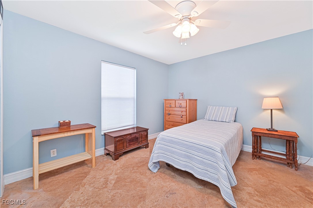 18217 Sycamore Road Fort Myers, FL 33967 - Photo 28 of 35 a bedroom with a bed and a chandelier