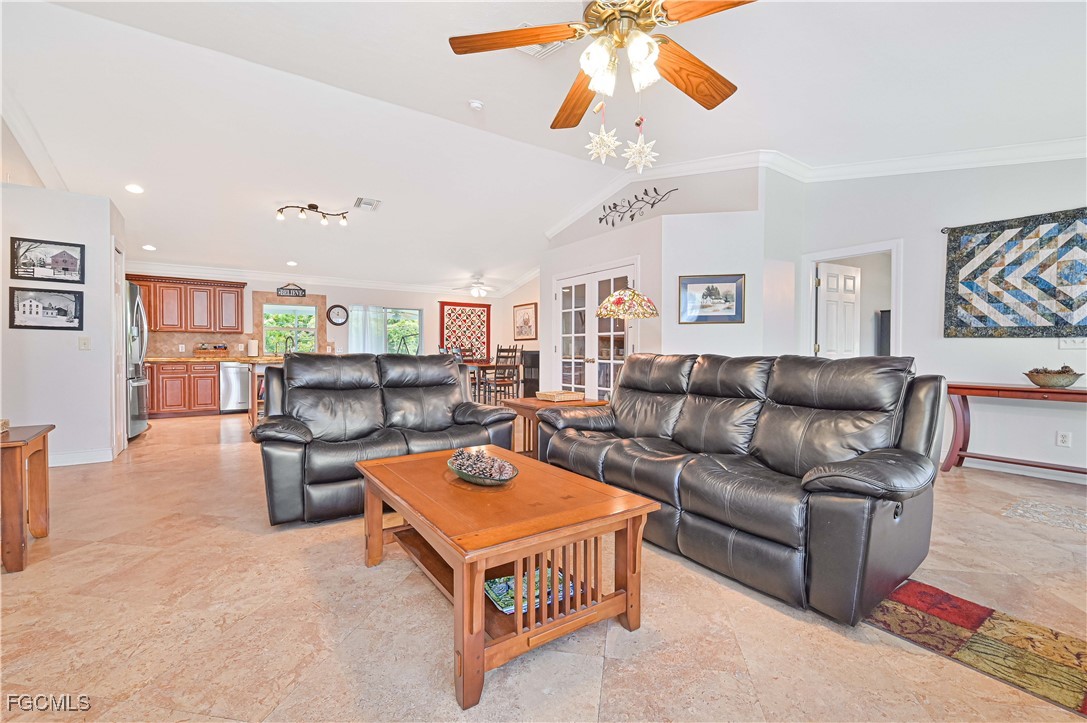 18217 Sycamore Road Fort Myers, FL 33967 - Photo 7 of 35 a living room with furniture and a chandelier
