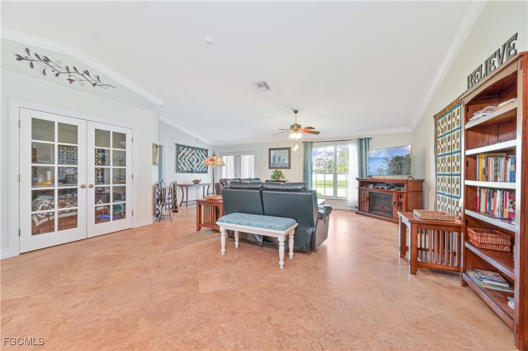 18217 Sycamore Road Fort Myers, FL 33967 - Photo 9 of 35 a living room with furniture and a book shelf