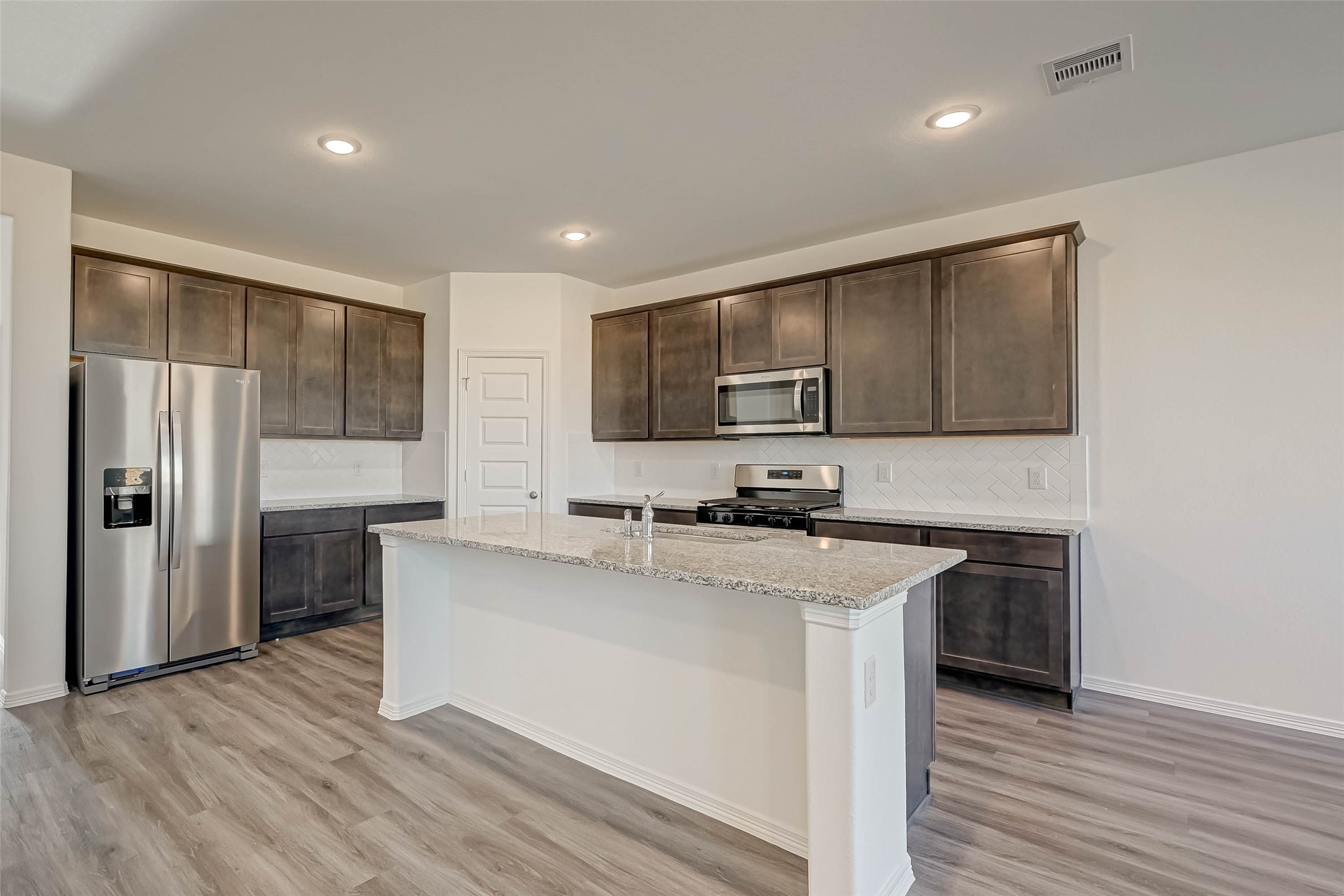 23226 Morning Splendor Drive Katy, TX 77493 - Photo 6 of 22 a kitchen with stainless steel appliances a sink stove and refrigerator