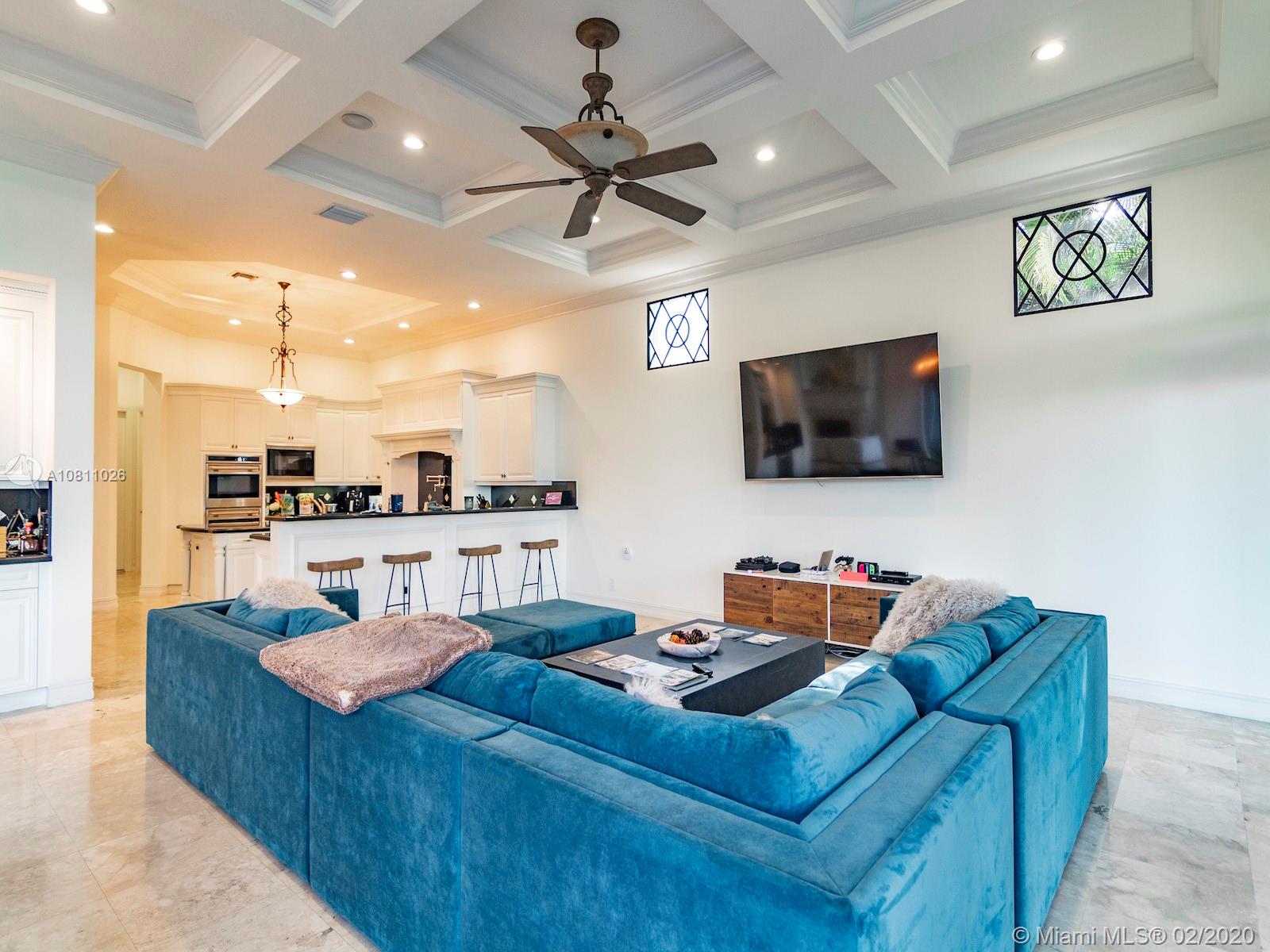 9597 Bridgebrook Drive Boca Raton, FL 33496 - Photo 13 of 37 a living room with furniture and a flat screen tv