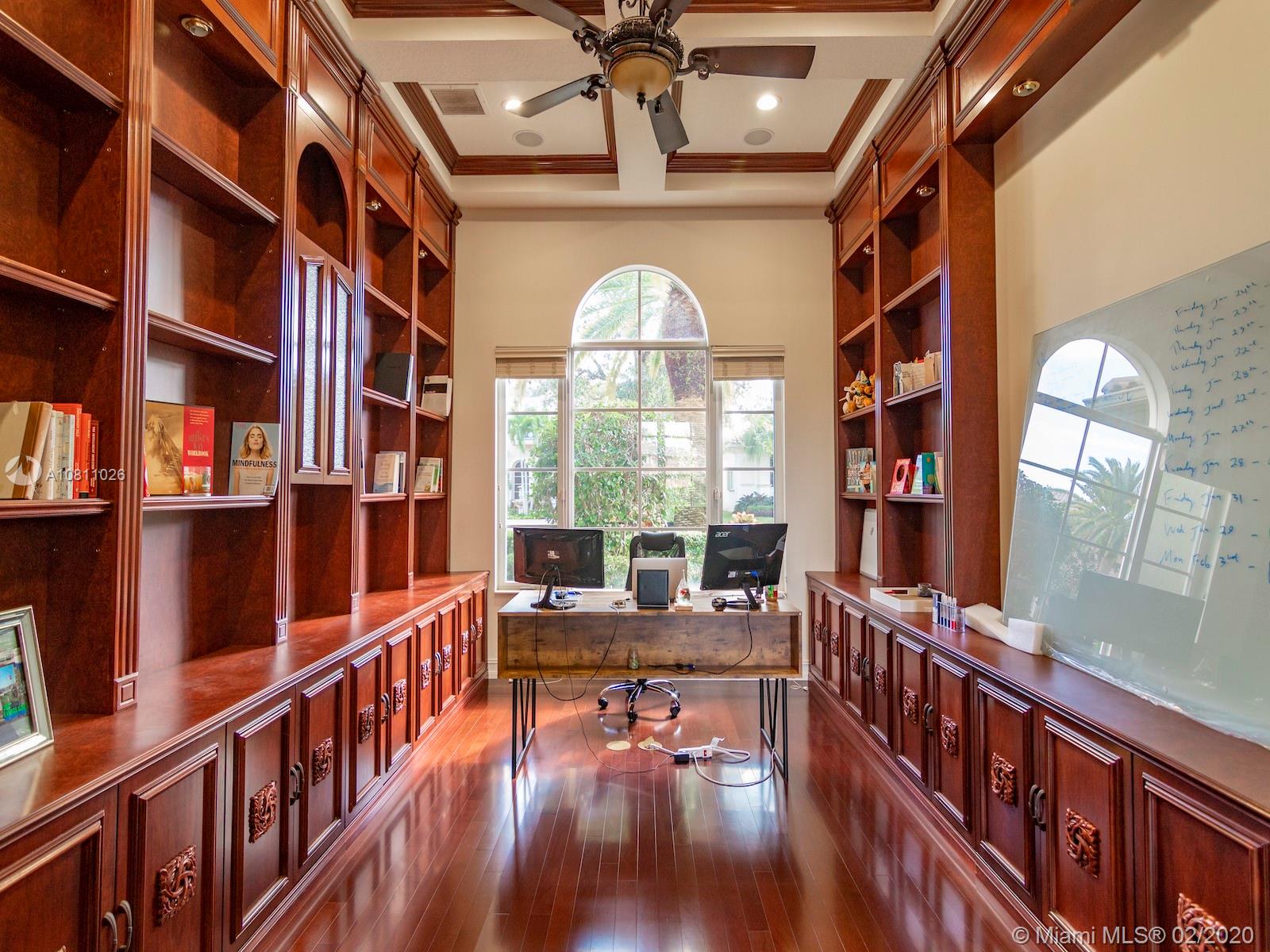 9597 Bridgebrook Drive Boca Raton, FL 33496 - Photo 14 of 37 a view of living room with wooden floor and book shelf