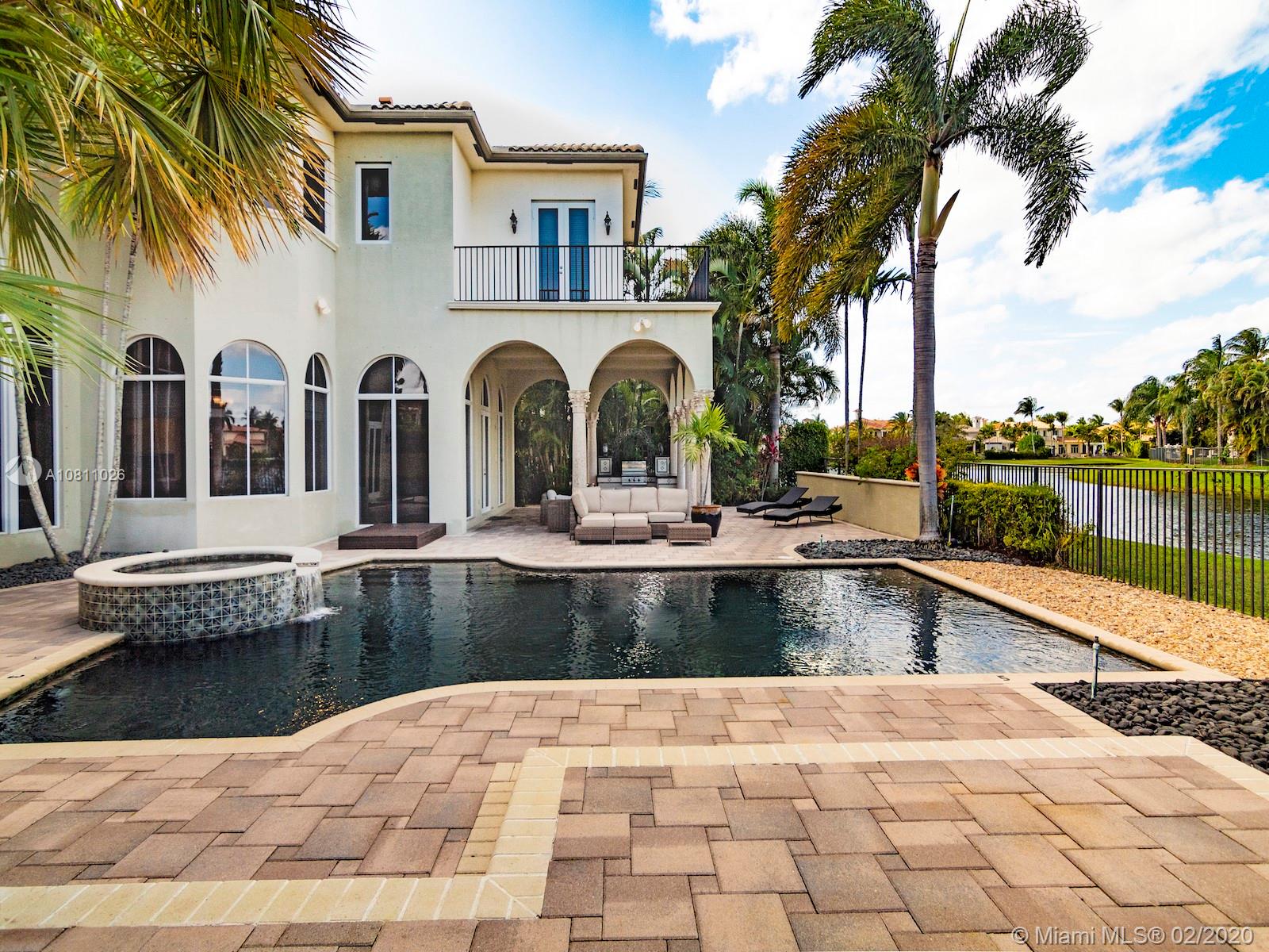 9597 Bridgebrook Drive Boca Raton, FL 33496 - Photo 21 of 37 a view of a swimming pool with a lounge chairs