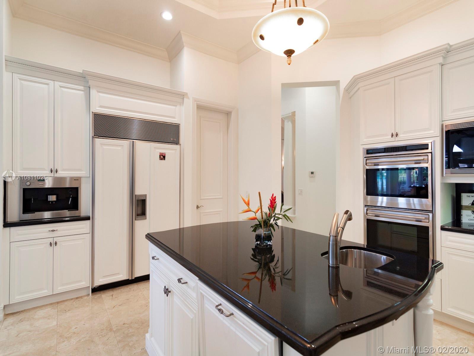 9597 Bridgebrook Drive Boca Raton, FL 33496 - Photo 28 of 37 a kitchen with stainless steel appliances a sink a stove and microwave