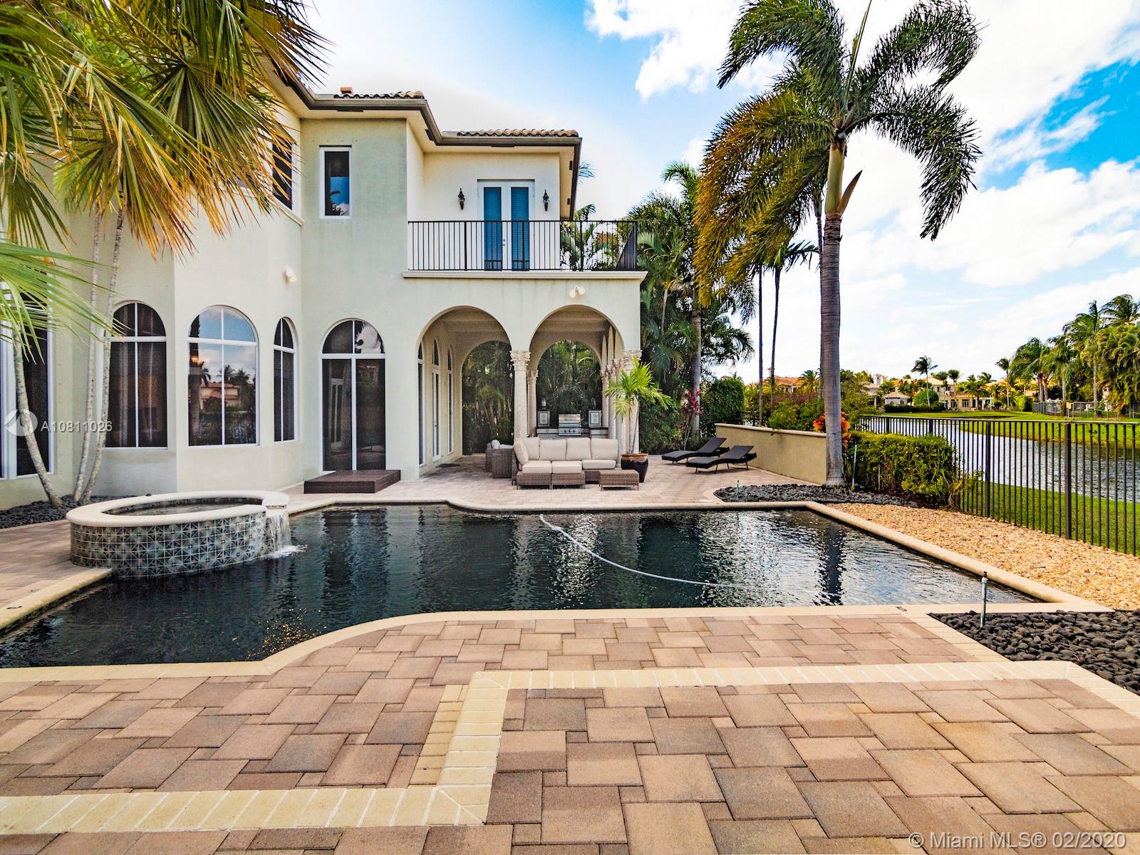 9597 Bridgebrook Drive Boca Raton, FL 33496 - Photo 31 of 37 a view of a swimming pool with a lounge chairs