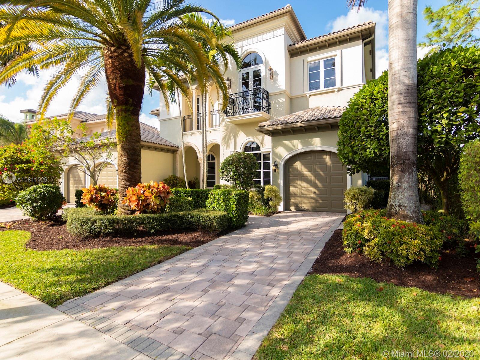 9597 Bridgebrook Drive Boca Raton, FL 33496 - Photo 32 of 37 a front view of a house with garden