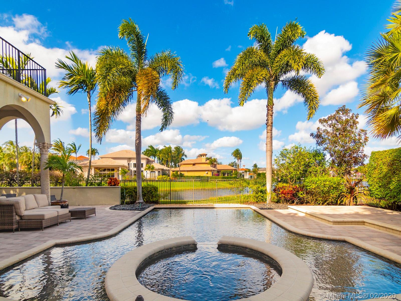 9597 Bridgebrook Drive Boca Raton, FL 33496 - Photo 7 of 37 a view of swimming pool with outdoor seating and city in the background