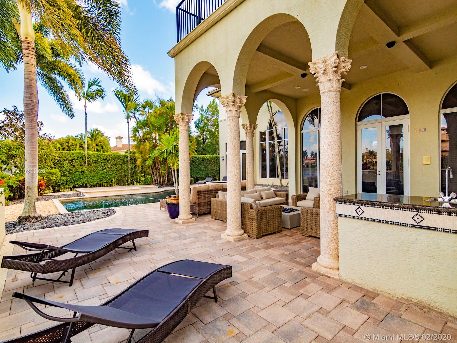 9597 Bridgebrook Drive Boca Raton, FL 33496 - Photo 8 of 37 a swimming pool with outdoor seating