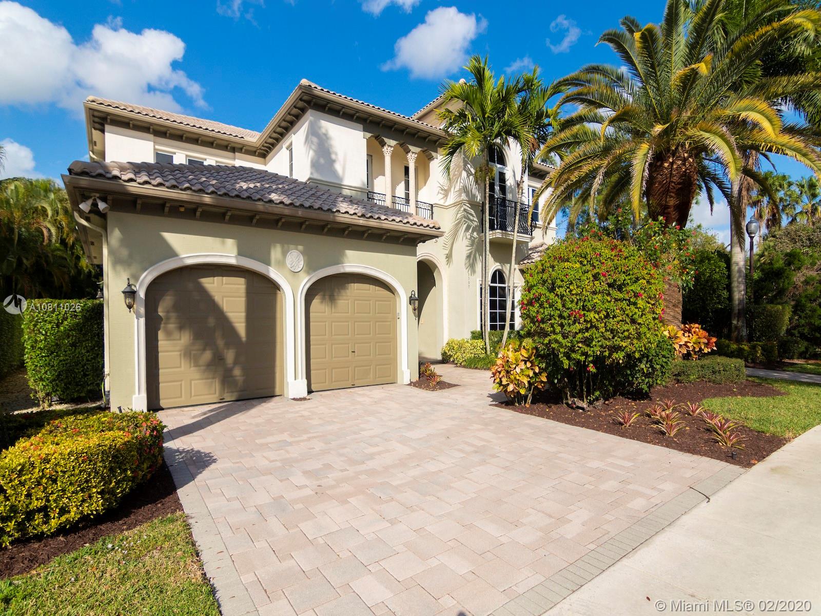 9597 Bridgebrook Drive Boca Raton, FL 33496 - Photo 9 of 37 a front view of a house with a yard