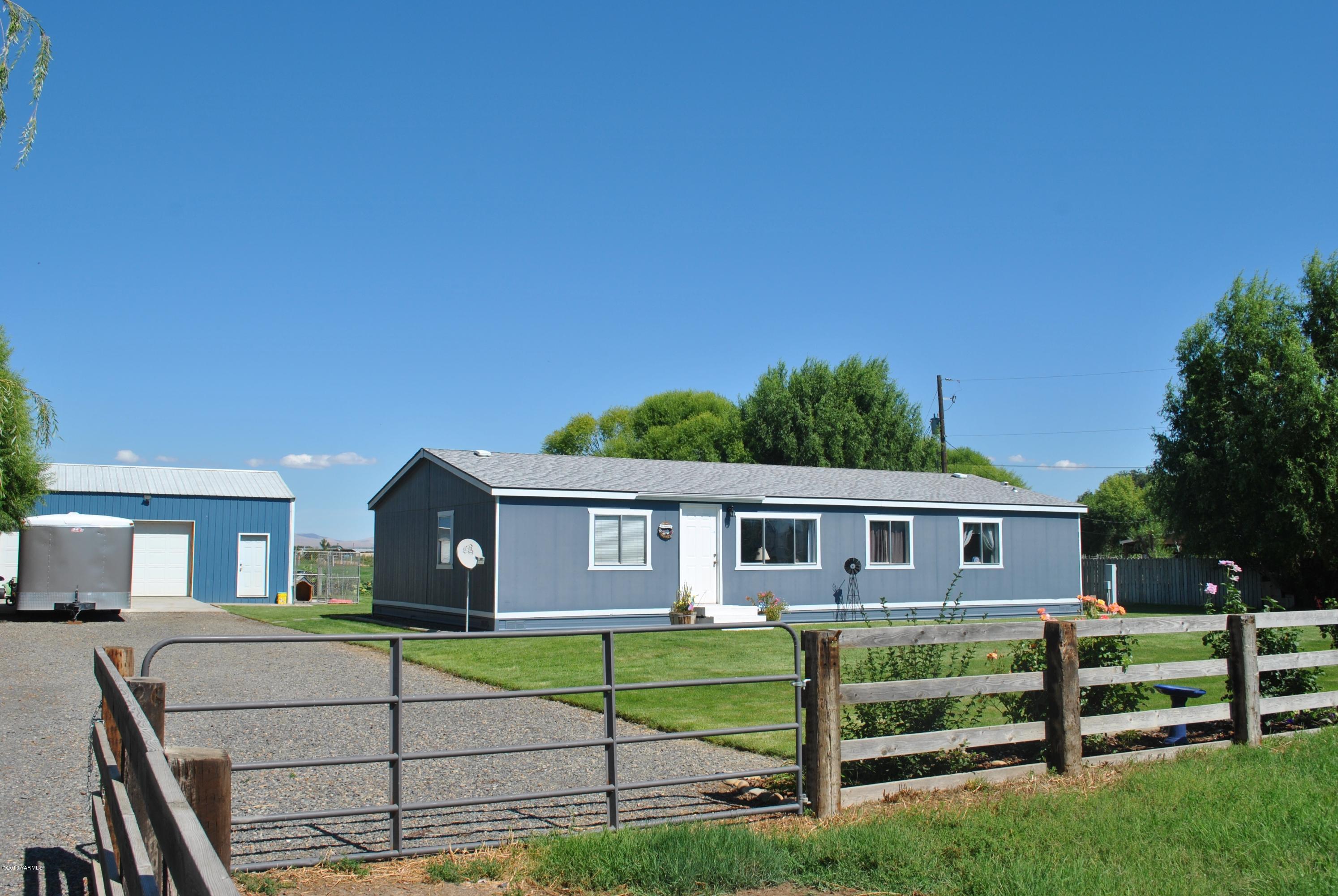 1231 Holaday Road Mabton, WA 98935 - Photo 1 of 29 a front view of a house with a yard