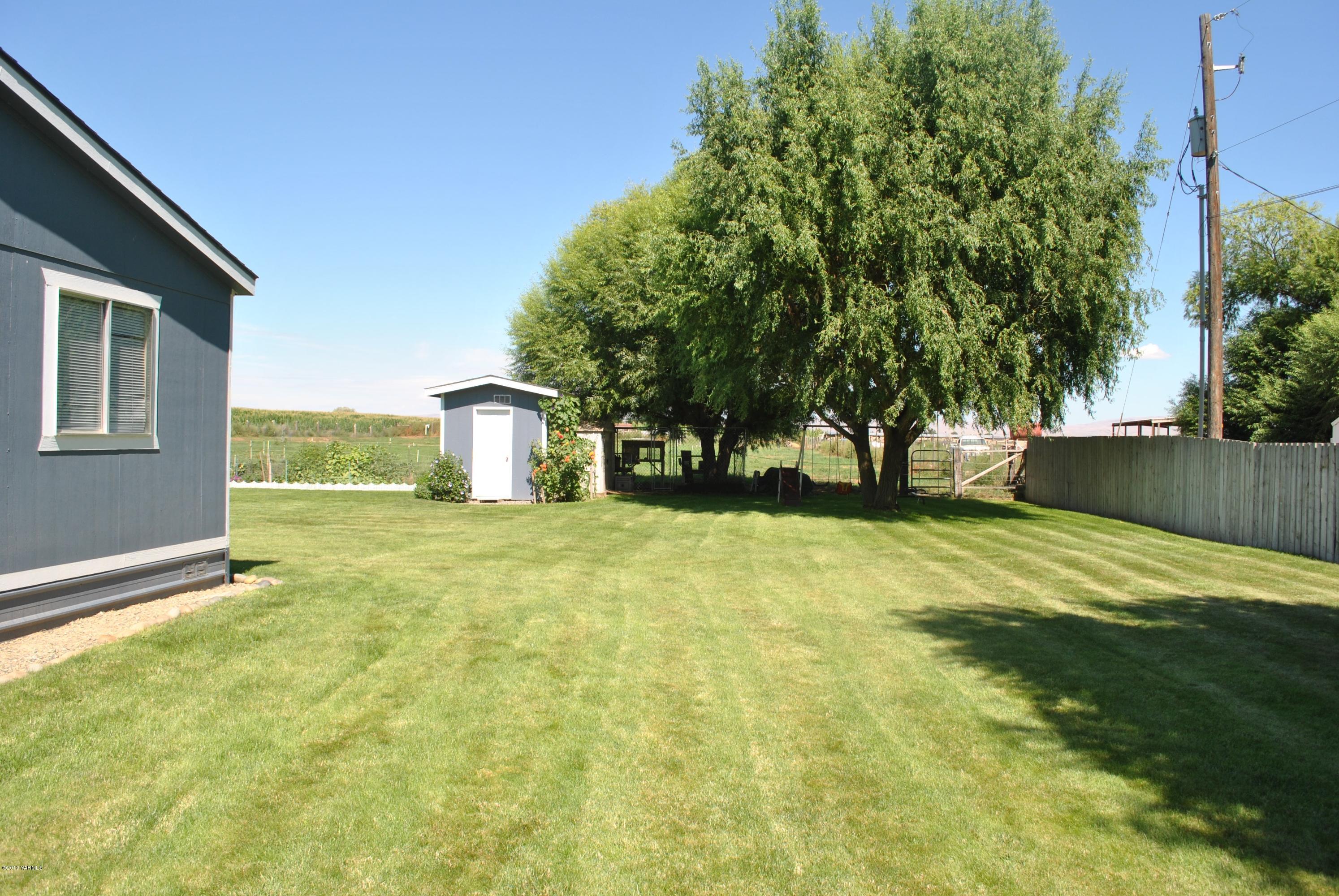 1231 Holaday Road Mabton, WA 98935 - Photo 22 of 29 a view of a house with a yard