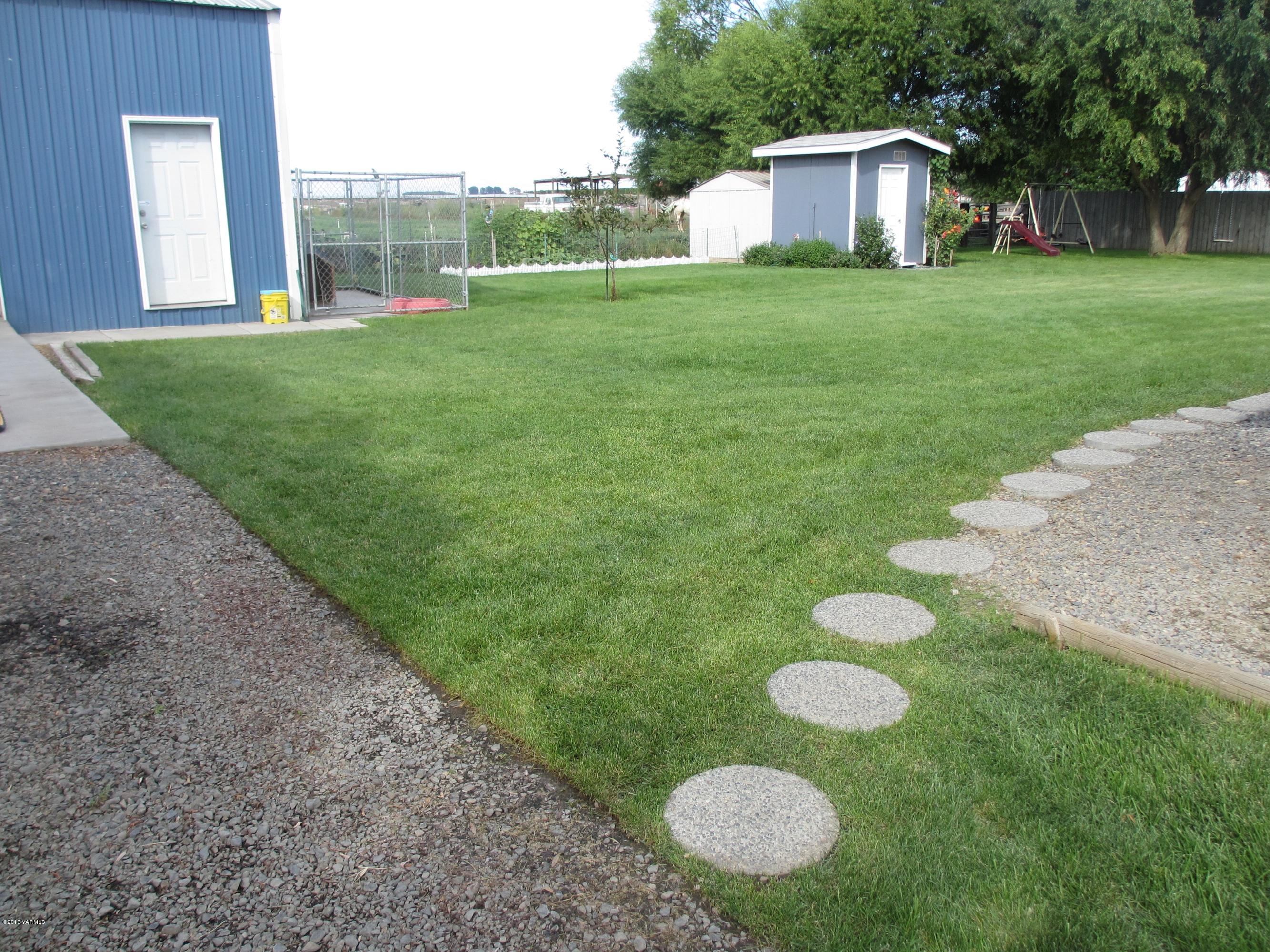 1231 Holaday Road Mabton, WA 98935 - Photo 23 of 29 a view of a house with a backyard