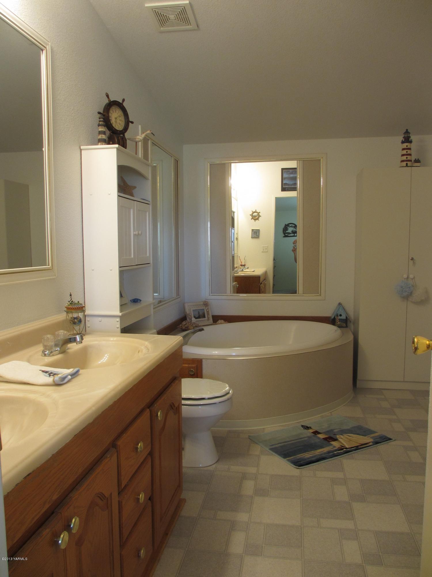 1231 Holaday Road Mabton, WA 98935 - Photo 29 of 29 a bathroom with a granite countertop sink mirror and toilet