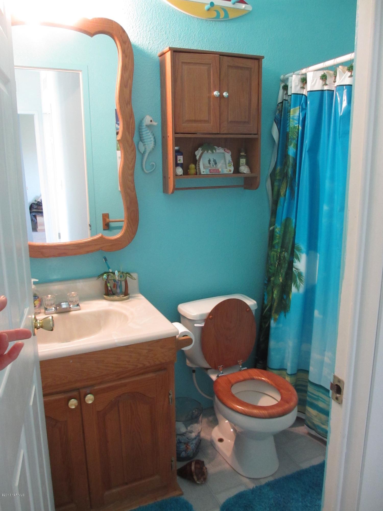 1231 Holaday Road Mabton, WA 98935 - Photo 6 of 29 a bathroom with a toilet sink and mirror