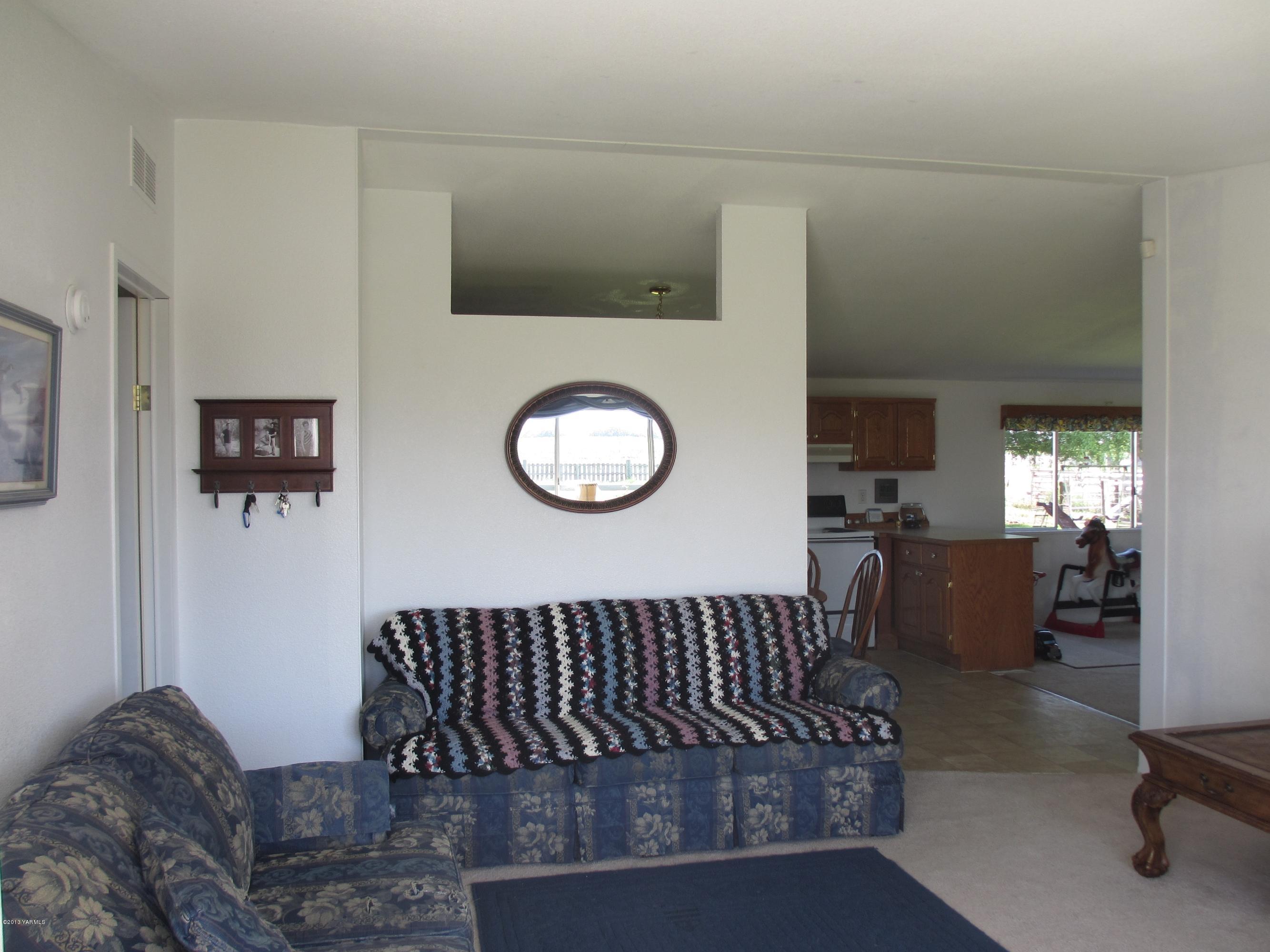 1231 Holaday Road Mabton, WA 98935 - Photo 7 of 29 a living room with furniture a flat screen tv and a large window
