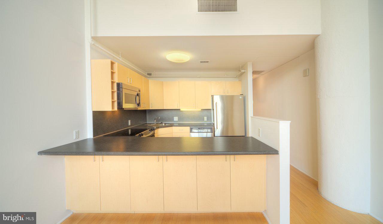 2300 Walnut Street, Unit 1B714 Philadelphia, PA 19103 - Photo 1 of 11 a view of a kitchen with kitchen island a sink and a large window