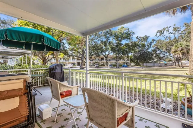 a view of an outdoor sitting area with furniture and umbrella