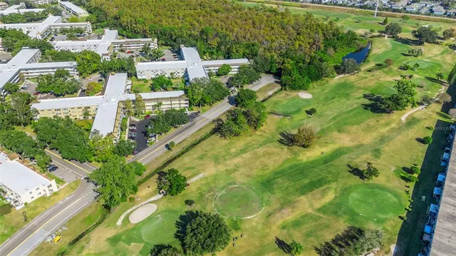 a dining hall with stainless steel appliances kitchen island granite countertop a dining table and chairs