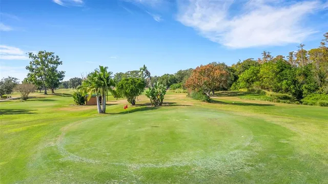a view of building with river and trees in the background