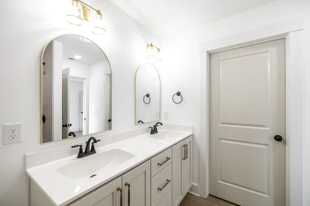 a bathroom with a double vanity sink and a mirror