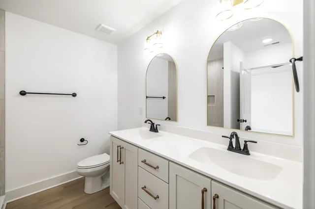 a bathroom with a double vanity sink and a mirror