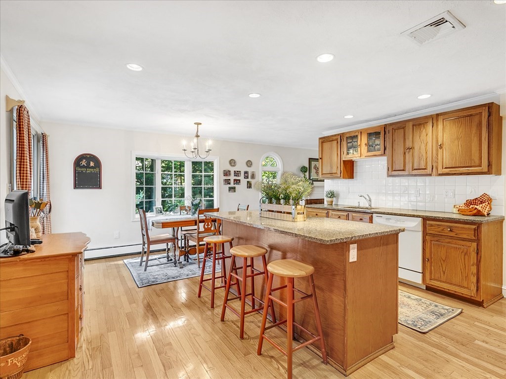 108 Meadowbrook Road Needham, MA 02492 - Photo 12 of 38 a large kitchen with lots of counter and chairs
