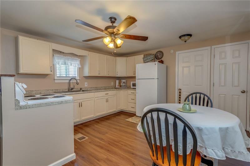 1858 Shenango Road Wampum, PA 16157 - Photo 3 of 15 THIS VIEW OF THE EAT-IN KITCHEN SHOWS THE LOVELY FAN/LIGHT AND DOOR LEADING TO MASTER BEDROOM.