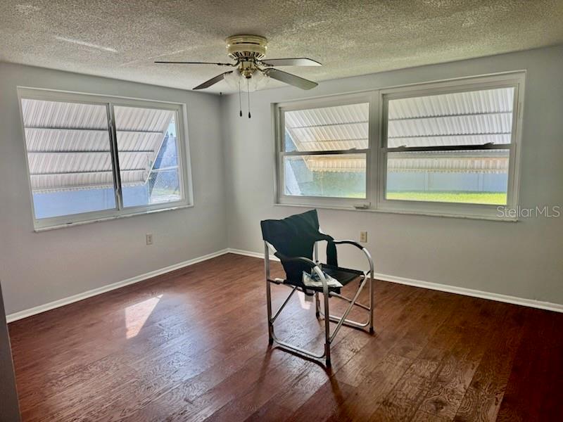 9617 Lake Chrise Lane Port Richey, FL 34668 - Photo 3 of 6 a workspace with wooden floor and a window