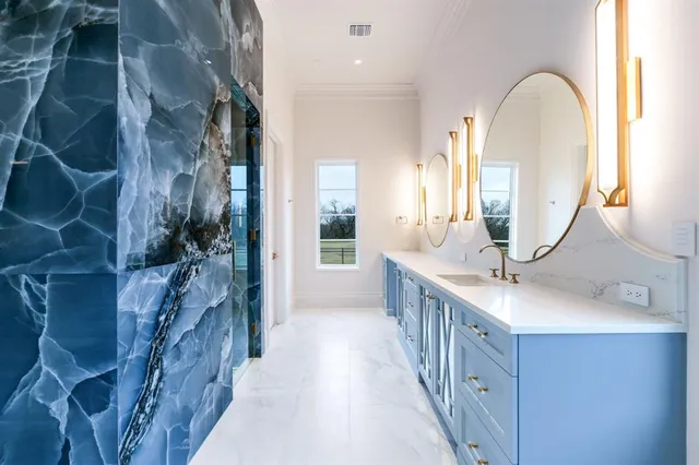 a bathroom with a double vanity sink and a mirror